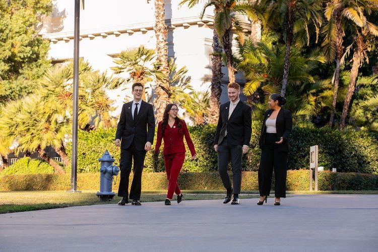 Four students walk by the California State Capitol Building 