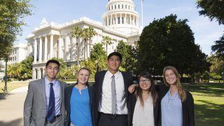 students standing in front of state capitol