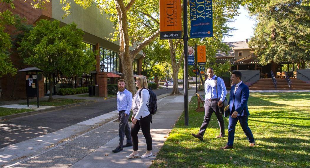 students crossing the street next to the sacramento campus quad